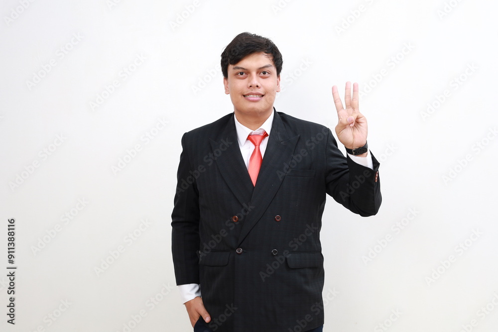 Young and handsome Asian businessman in a suit showing number three hand gestures. Young and handsome Asian businessman in a suit showing number three hand gestures.