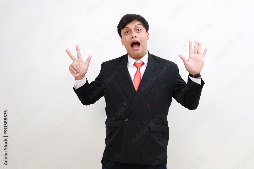Young and handsome Asian businessman in a suit showing number eight hand gestures. Young and handsome Asian businessman in a suit showing number eight hand gestures.