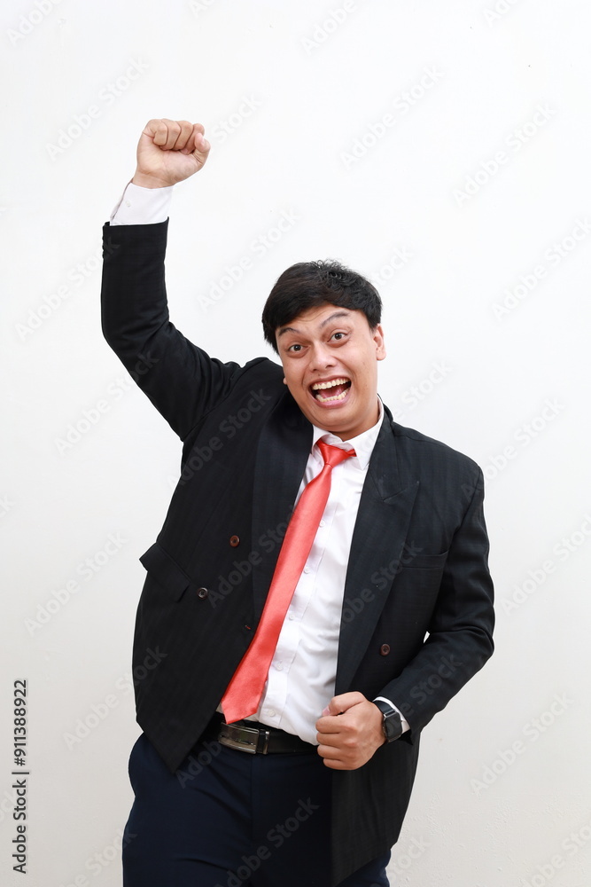 Business winner, happy young asian businessman in formal wear celebrating, gesturing, keeping arms raised and expressing positivity. Isolated on white Business winner, happy young asian businessman in formal wear celebrating, gesturing, keeping arms raised and expressing positivity. Isolated on white