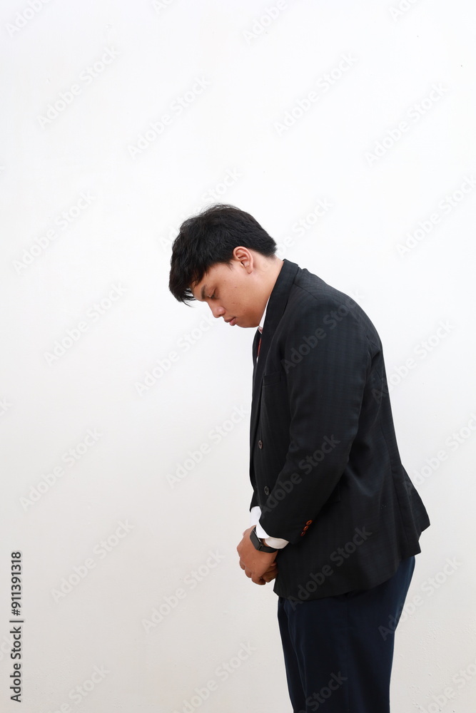 Side profile portrait sad upset asian businessman looking down. isolated on white background. Human face expression emotion feeling Side profile portrait sad upset asian businessman looking down. isolated on white background. Human face expression emotion feeling