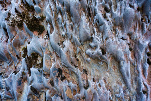 Abstract weathered rocky limestone mountain cave with lichen surface photo