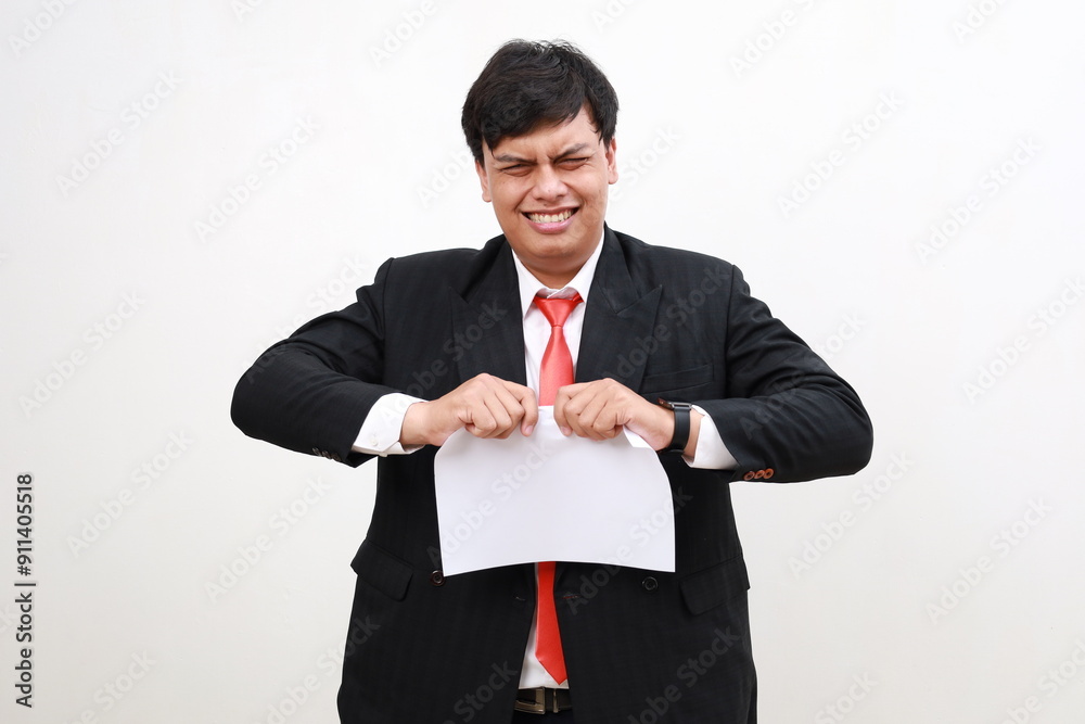 Stressed Young asian Businessman tearing blank paper apart, isolated on white background Stressed Young asian Businessman tearing blank paper apart, isolated on white background