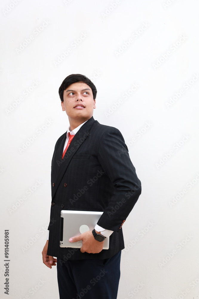 Asian Businessman wearing a black suit, handsome cool sharp smart standing looking, hand holding tablet computer ready for work. Isolated on white background Asian Businessman wearing a black suit, handsome cool sharp smart standing looking, hand holding tablet computer ready for work. Isolated on white background