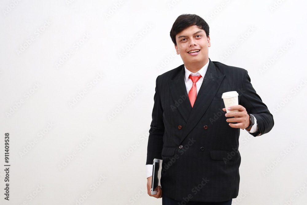 Portrait of smiling businessman. Carrying tablet computer and cup of coffee. Standing isolated white background. Copy space. Portrait of smiling businessman. Carrying tablet computer and cup of coffee. Standing isolated white background. Copy space.