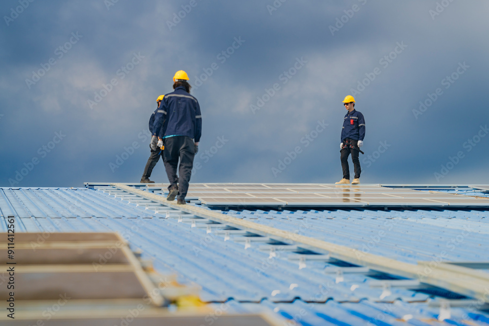 Worker Technicians are working to construct solar panels system on roof. Installing solar photovoltaic panel system. Men technicians walking on roof structure to check photovoltaic solar modules. Worker Technicians are working to construct solar panels system on roof. Installing solar photovoltaic panel system. Men technicians walking on roof structure to check photovoltaic solar modules.