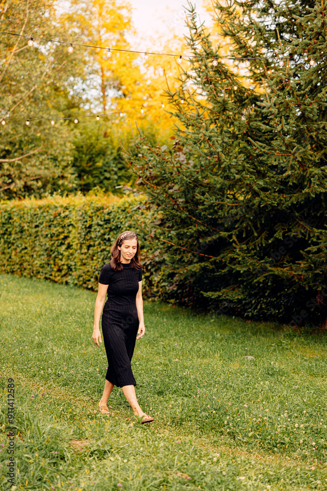 serene garden, a radiant girl walks barefoot, illuminated by the golden hues of the setting sun in a captivating outdoor shot. serene garden, a radiant girl walks barefoot, illuminated by the golden hues of the setting sun in a captivating outdoor shot.