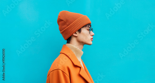 Asian model in a beanie and coat. Fall winter fashion concept.