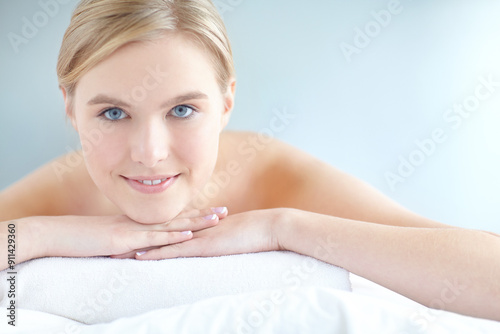 Massage, relax and spa with portrait of woman customer on table for break, treatment or wellness. Luxury, peace and satisfaction with person on white background in salon for comfort or stress relief