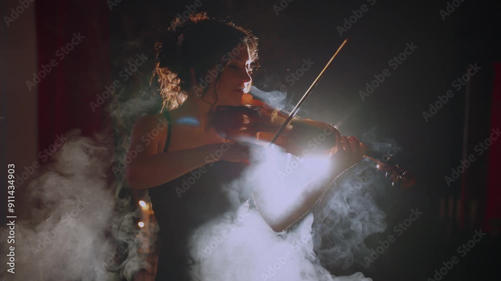 professional performer musician woman violinist playing the violin in night club. Girl musician hands in motion art music artist on stage. Black silhouette dark room full smoke magic light sexy lady