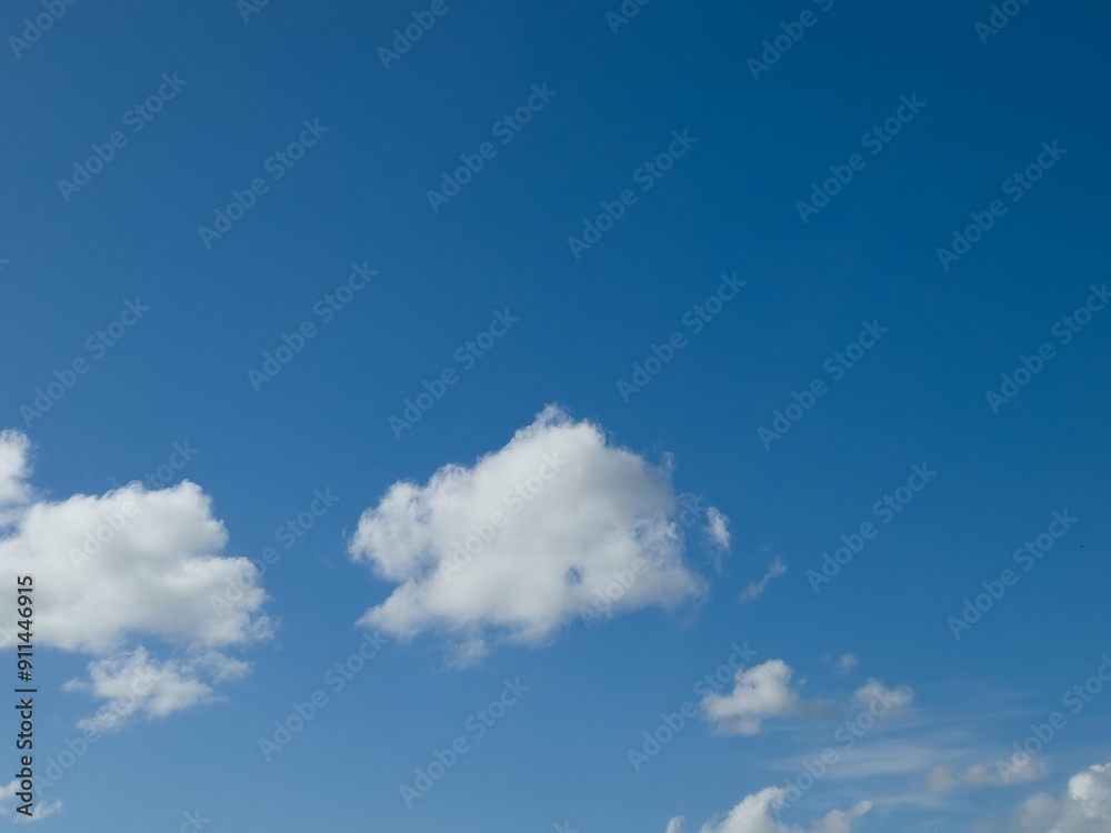 Summer white fluffy cumulus clouds in the deep blue sky Summer white fluffy cumulus clouds in the deep blue sky