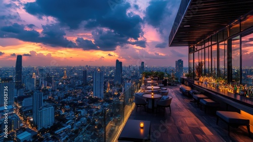 Aerial view of Bangkok cityscape from a rooftop bar, with sunset hues and the illuminated Lumpini area.