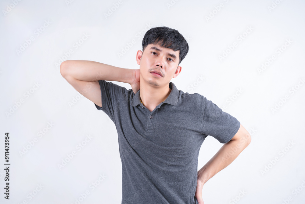 Portrait of handsome Asian man with pain in his shoulder and neck muscles due to accumulated aches. Medical and healthcare concept on white background. Portrait of handsome Asian man with pain in his shoulder and neck muscles due to accumulated aches. Medical and healthcare concept on white background.