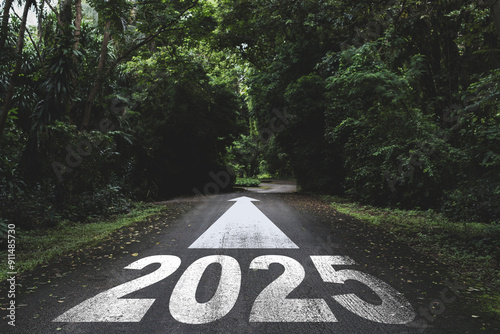 New year 2025 or straight forward concept. Text 2025 written on the road in the forest. Concept of planning, goal, challenge, new year resolution..