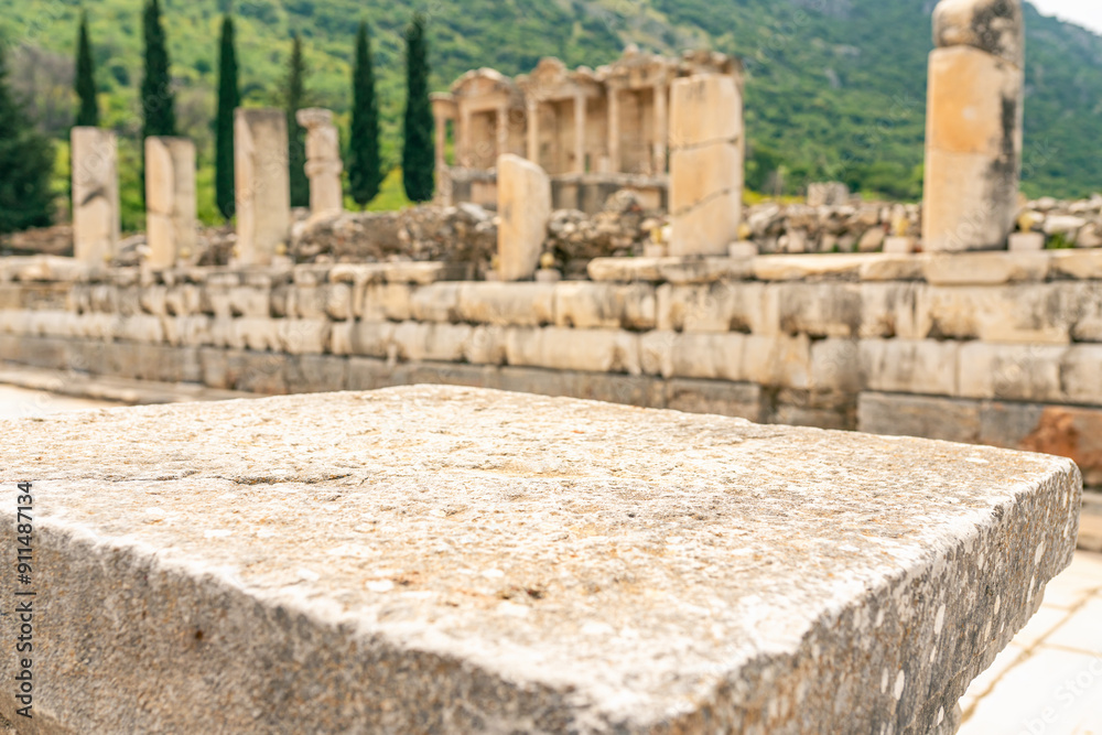 Ancient marble column as podium with background of ruins antique town. Pedestal platform for show product placement Ancient marble column as podium with background of ruins antique town. Pedestal platform for show product placement