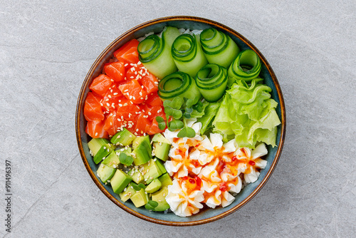 Hawaiian salmon poke bowl with avocado, Top view, gray background