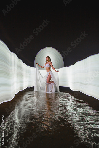 Obraz na płótnie Young slim girl posing in water with abstract light effect w salonie