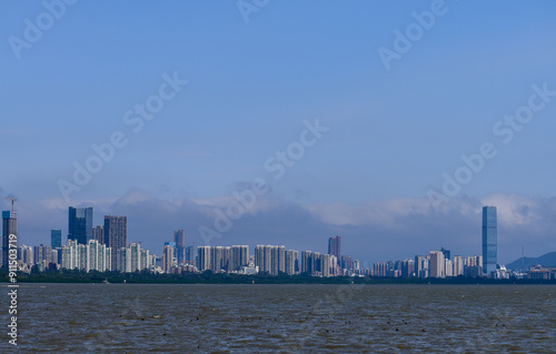 The view Cityscape of Shenzhen, Guangdong, China from the shore of Shenzhen Bay. City in the summer day. Modern city waterfront downtown skyline,China. Nature and landscape. photo