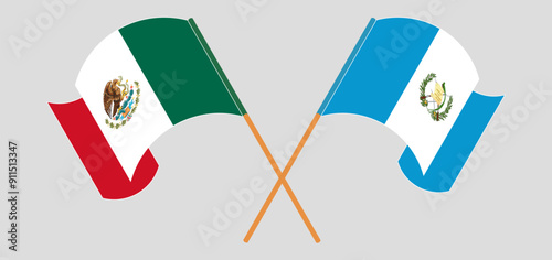Crossed and waving flags of Mexico and Republic of Guatemala