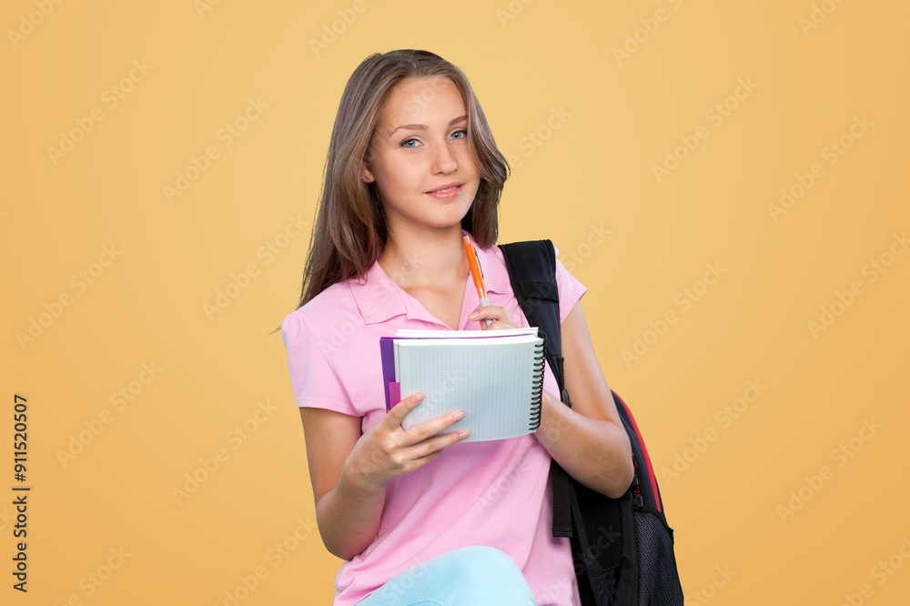 Fototapeta premium Young happy student holding books