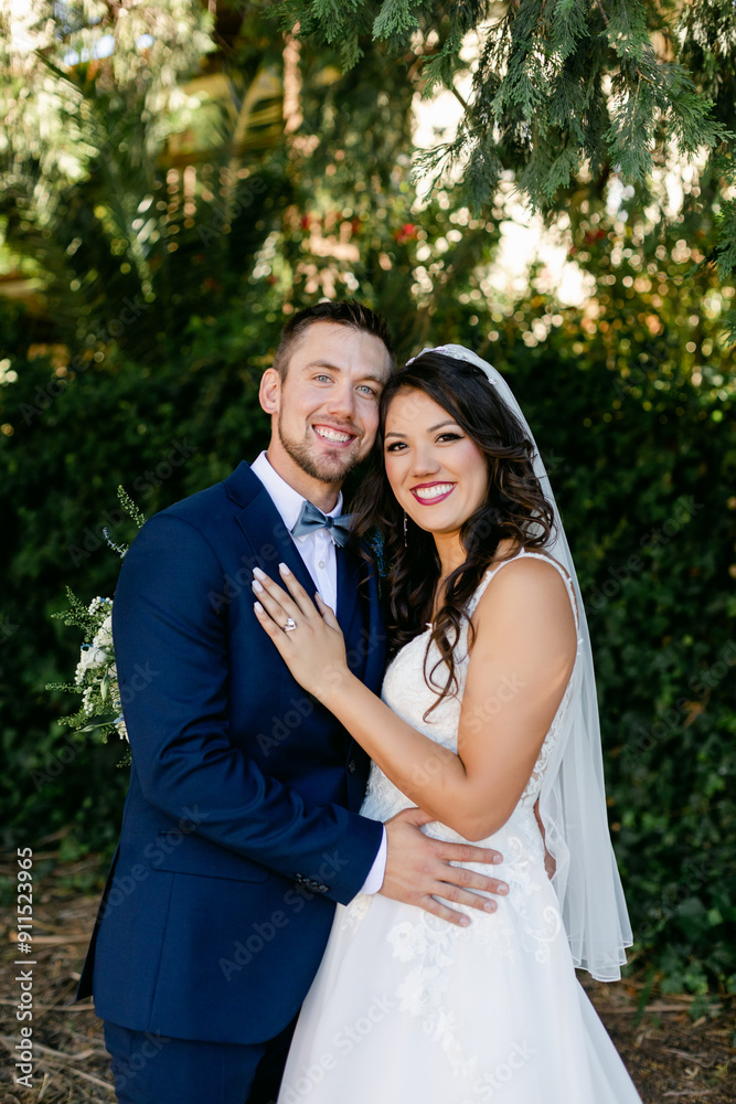Smiling Bride and Groom Pose for a Portrait on Their Wedding Day