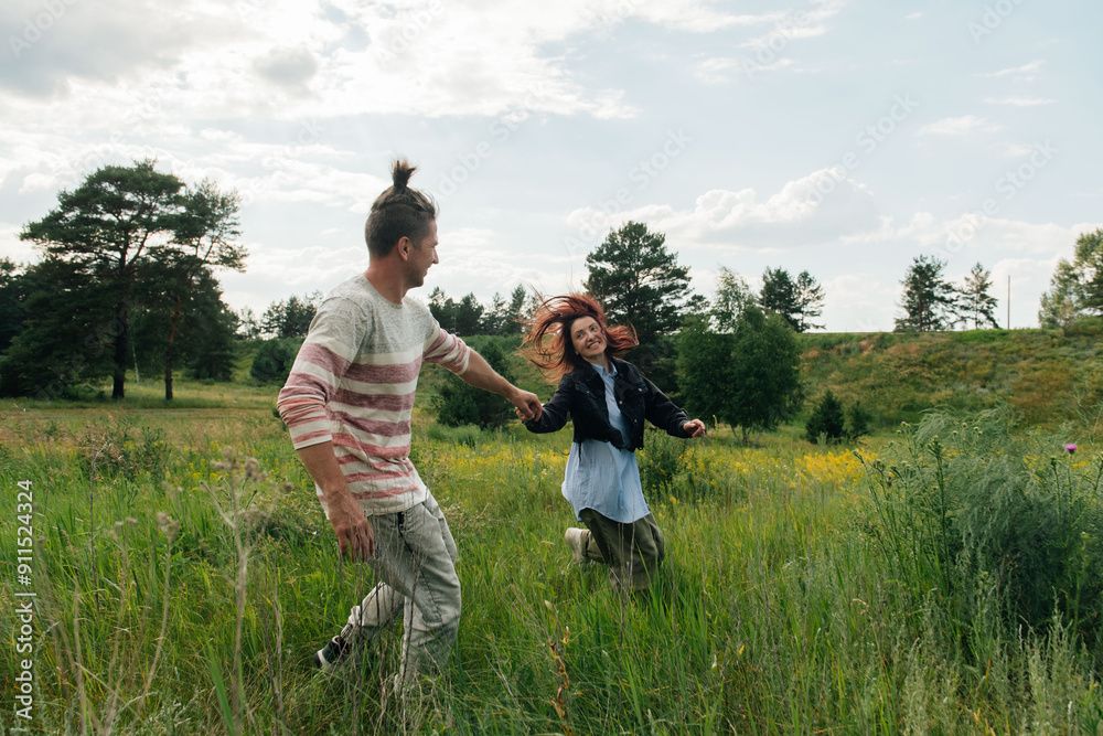 Couple Holding Hands and Running in a Meadow
Couple Holding Hands and Running in a Meadow