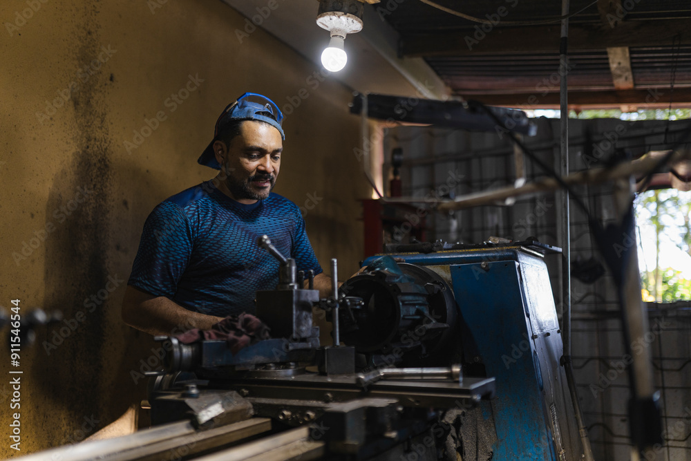 man in a precision mechanics workshop man in a precision mechanics workshop