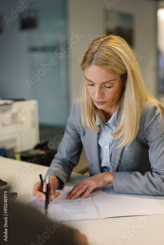 Woman car consultant finalization transaction dealership photo