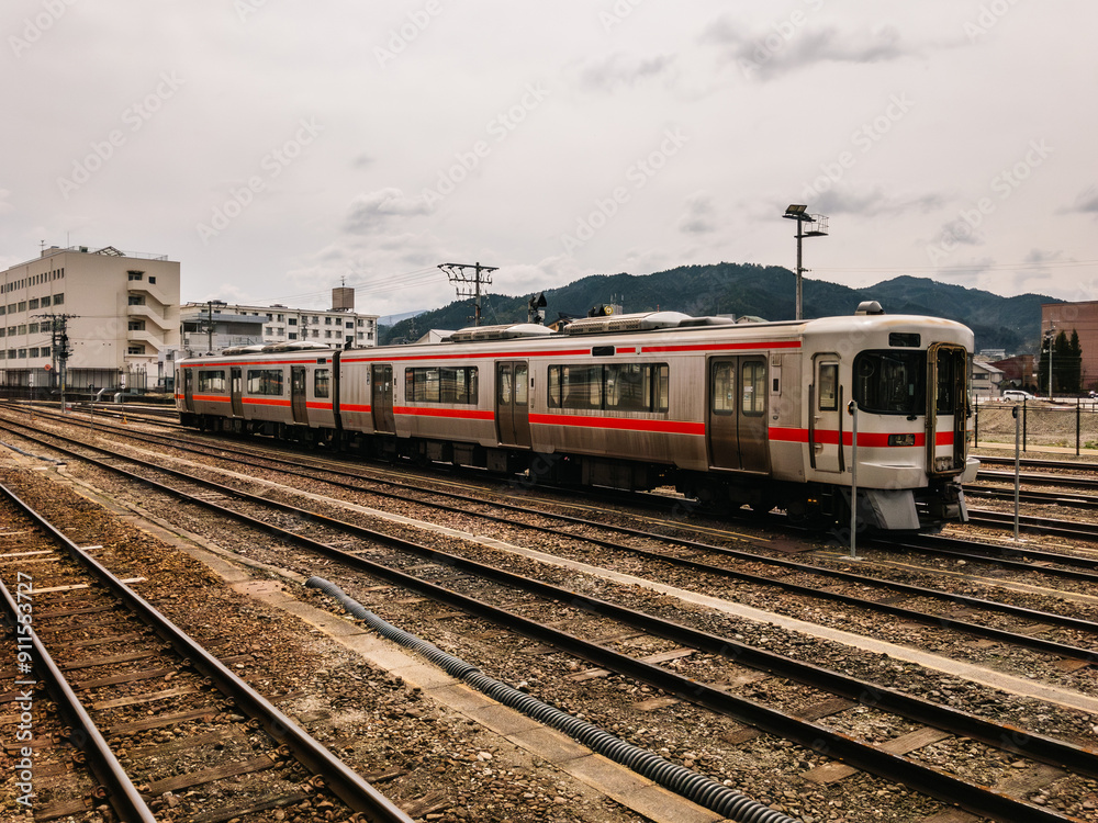 A modern train stands on the railway tracks at a station A modern train stands on the railway tracks at a station
