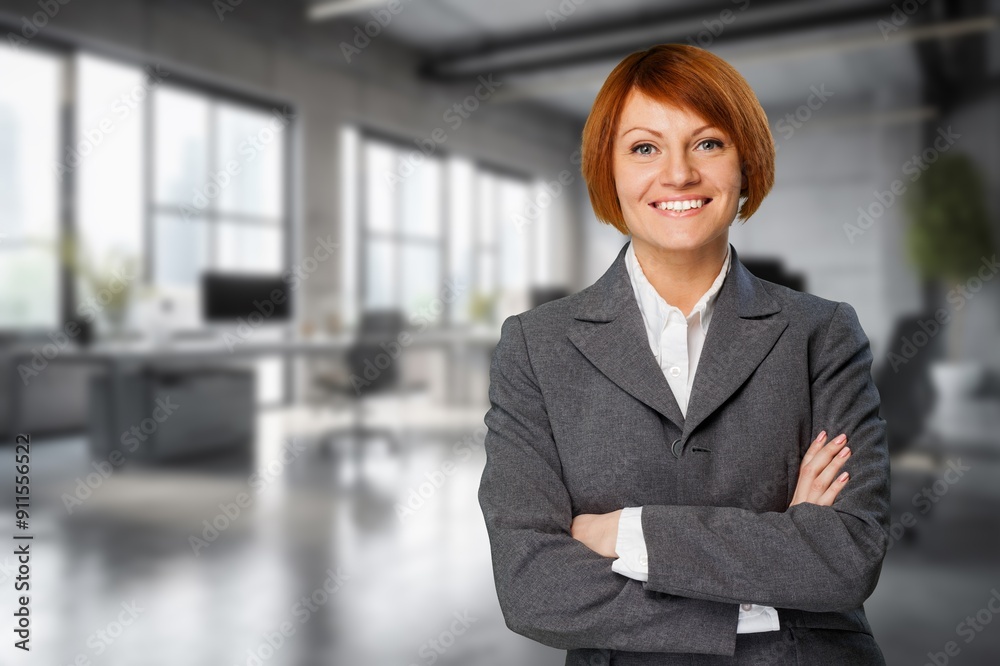 Happy and successful businesswoman posing in office. Happy and successful businesswoman posing in office.