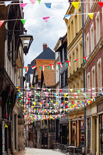 Fototapeta Naklejka Na Ścianę i Meble -  Rouen, Normandy, France, Damiette street, famous for its antique shops, traditional colorful half-timbered houses and narrow cobbled streets and flag decoration during Armada tall ship festival