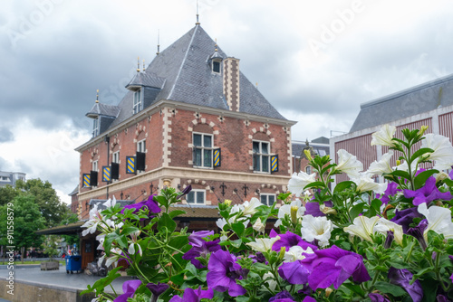 flowers in front of old weigh house in Leeuwarden, which is capital of Friesland and one of the Eleven Cities of Friesland in The  Netherlands