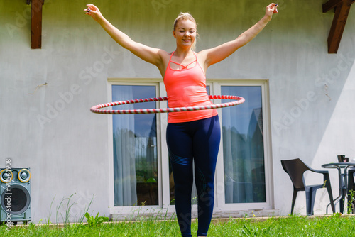 Young woman with hoola hoop outdoors photo