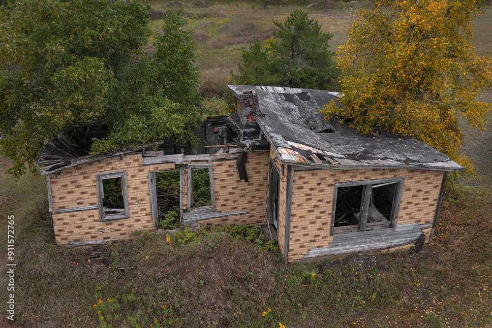 Dilapidated House With Trees Growing Through It