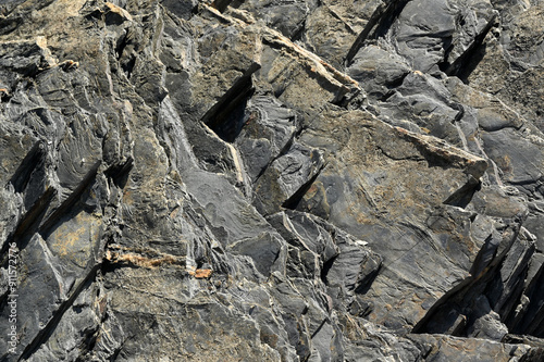 Canvastavla A wall of slate or granite rock stone rocky coast cliff, grey stone formation by the portugal atlantic sea