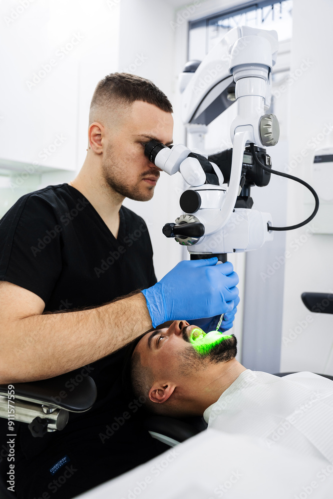 Dentist is looking on teeth condition by surgical digital microscope in dental clinic. Surgical microscope examination procedure. Dentist is looking on teeth condition by surgical digital microscope in dental clinic. Surgical microscope examination procedure.