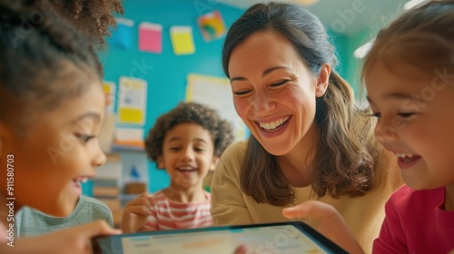 A close-up of a teacher engaging with a group of young students in an elementary school classroom, using a tablet to display interactive content, while the students eagerly gather around, their faces