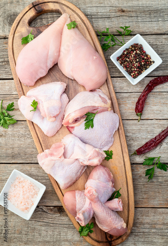 Raw mixed chicken meat parts  for cooking on rustic background photo