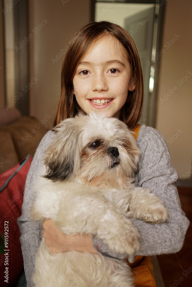 9-year-old girl holding a fluffy dog