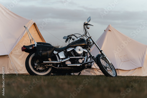 Tapeta Chopper style motorcycle parked next to large white tents, custom vintage motorb