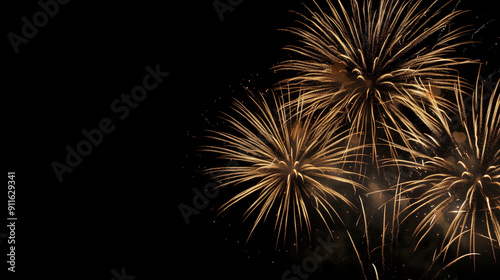 Golden fireworks explode against the dark night sky, creating dazzling patterns of light and sparks.