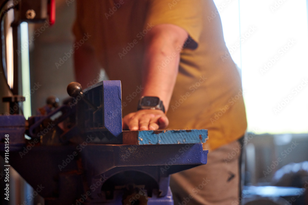 man sawing wood on a jointer in a home workshop man sawing wood on a jointer in a home workshop