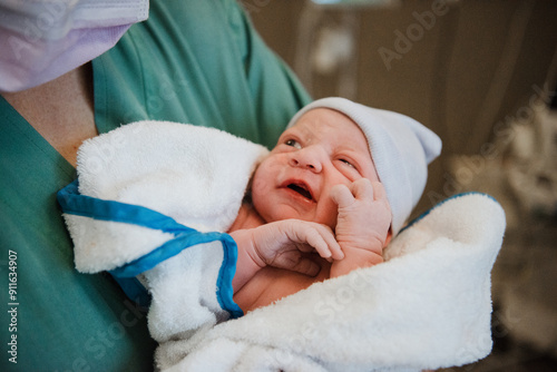 Newborn in a Blanket with a Blurred Background