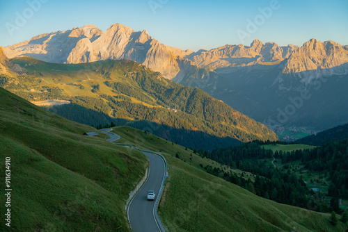 Car on winding road through Alps