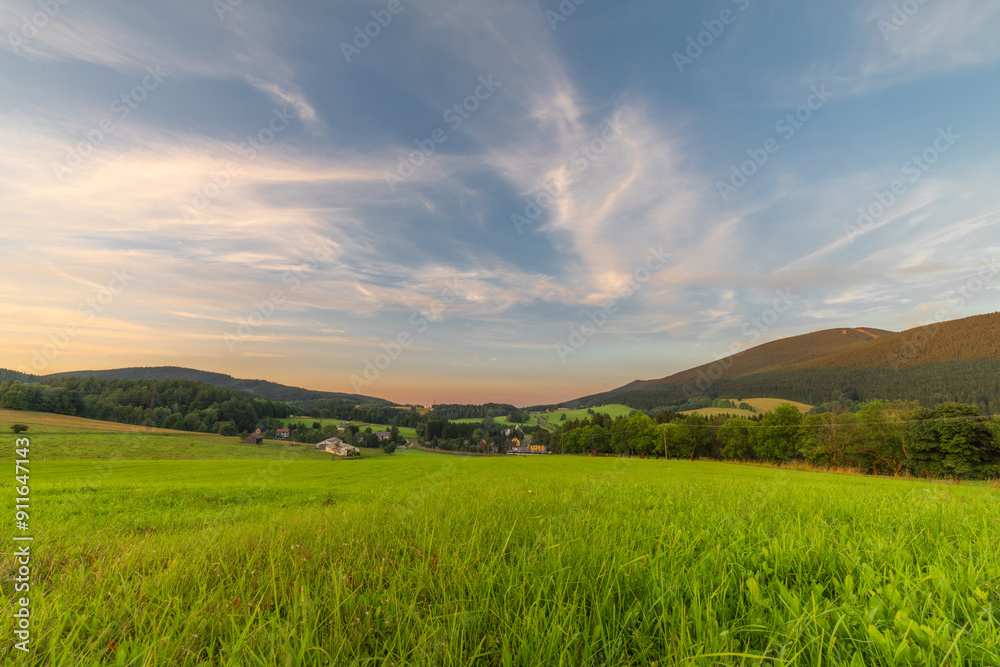 Fototapeta premium Green meadow with hills and fresh forests near Ramzova village