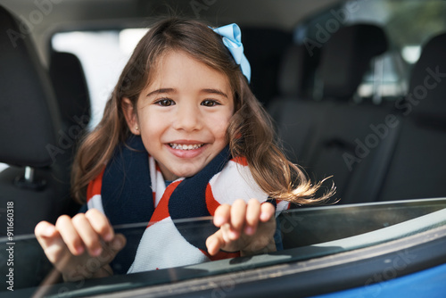 Girl, portrait and road trip in car for travel, excited and journey with explore, smile and vacation. Child, happy and fun adventure in suv by window for drive, holiday and sightseeing on weekend