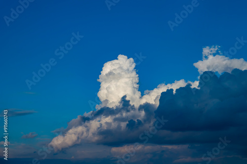 Thunderstorm cumulus clouds on blue sky. Cloudy weather. White cumulus clouds. Skies before thunderstorm. Background image. Beauty of nature. Outer space.