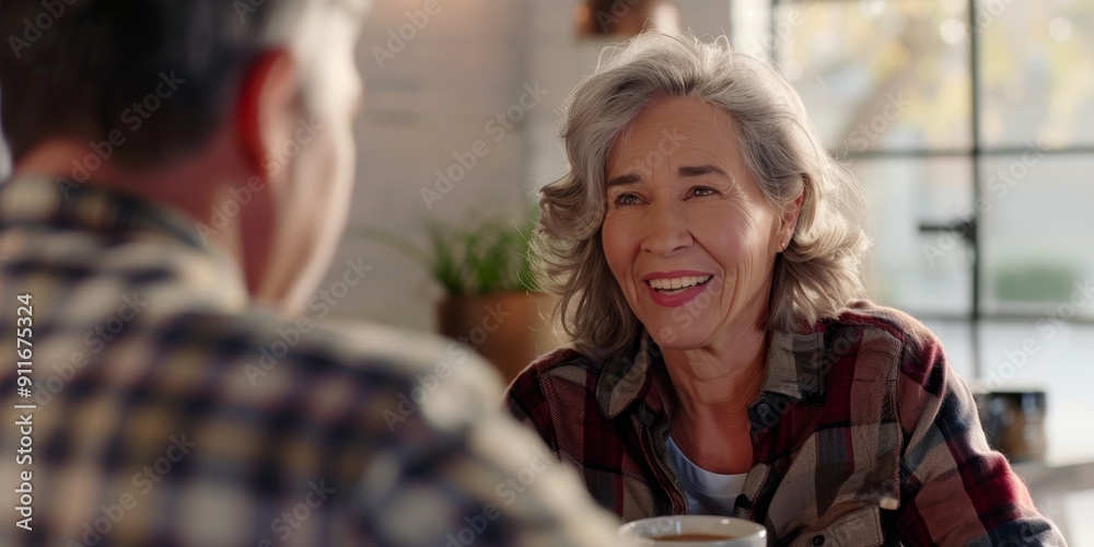 Obraz premium Toast to retirement and a senior couple sipping morning tea in their dining area. Smile, cheers, or chat with an older couple in their apartment for romance.