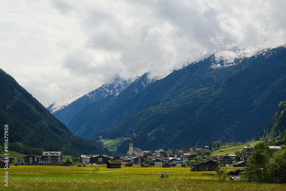 Austrian village with snowy mountains on background. Austrian village with snowy mountains on background.
