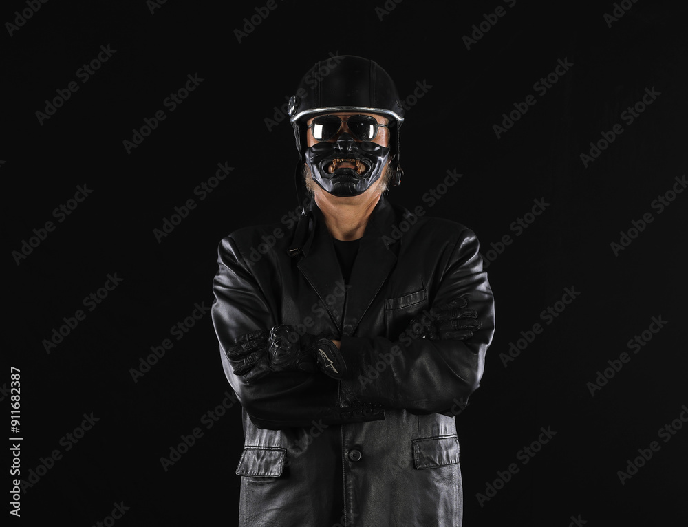 Portrait of a biker in a black helmet on a black background Portrait of a biker in a black helmet on a black background