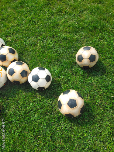 soccer balls on a green field, sports training. High quality photo